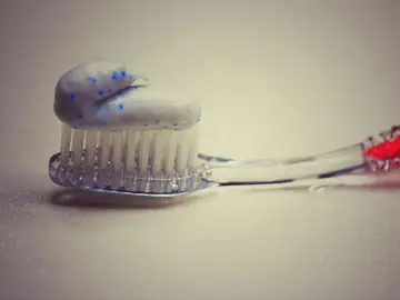 Un cepillo con pasta de dientes Un cepillo con pasta de dientes